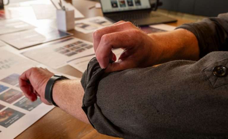 Image showing an office worker rolling up a sleeve